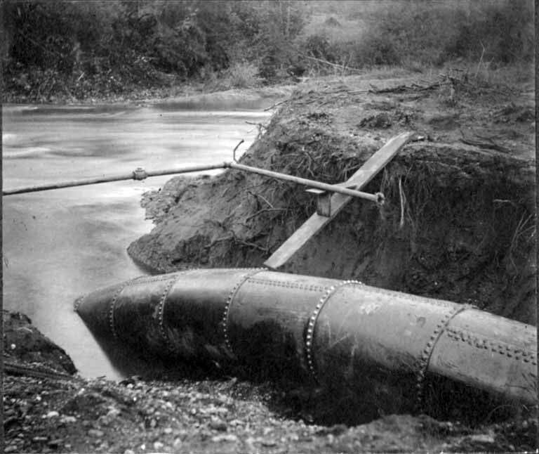 Completed pipeline entering the trench under the Black River, ca 1899 (SPWS 437) - via Wikimedia Commons (used under Public domain)